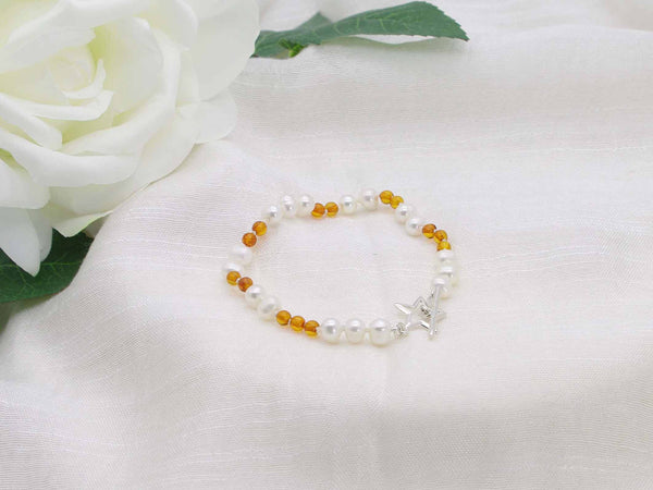 White pearl and cognac amber hand knotted bracelet with sterling silver star toggle from Jewellery by Linda