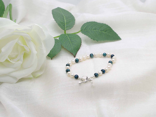 Ever Green hand knotted white and dark green pearl bracelet featuring a  heart and arrow sterling silver toggle clasp from Jewellery by Linda