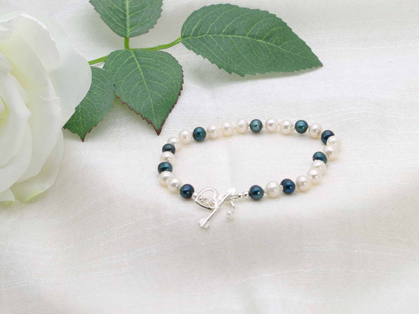 Ever Green hand knotted white and dark green pearl bracelet featuring a sterling silver  heart and arrow toggle clasp from Jewellery by Linda
