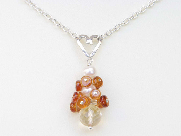 Diana necklace. Hessonite garnets, with a white freshwater cultured pearl and citrine. Suspended from a polished sterling silver handmade heart on a sterling silver chain. Jewellery by Linda Sweet Heart Collection. 46cm chain.
