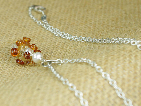 Diana necklace. Hessonite garnets, with a white freshwater cultured pearl and citrine. Suspended from a polished sterling silver handmade heart on a sterling silver chain. Sweet Heart Collection at Jewellery by Linda. 46cm chain. 3.5cm pendant