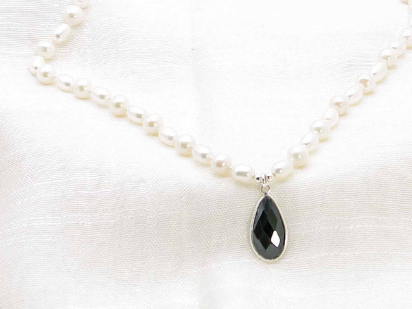 Hand knotted ivory culture pearl necklace with striking feature black spinel faceted drop.  Classic monochrome sophistication from Jewellery by Linda
