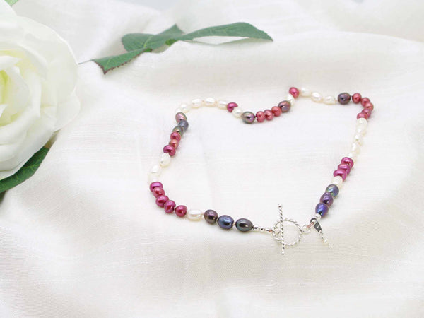 Very Berry hand knotted single strand of pearls in berry colours with a feature sterling silver rope design toggle clasp. Distinctive contemporary glamour from Jewellery by Linda