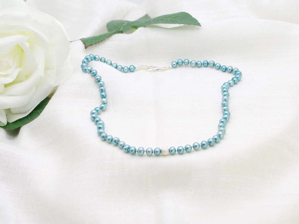 Striking elegant single strand of teal hand knotted pearls featuring a stardust sterling silver sphere from Jewellery by Linda. Light and comfortable to wear with bags of impact