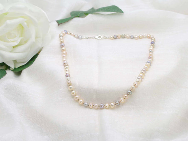 Single graceful strand of hand knotted pearls in subtle sophisticated tones. Classic necklace from Jewellery by Linda with a contemporary twist