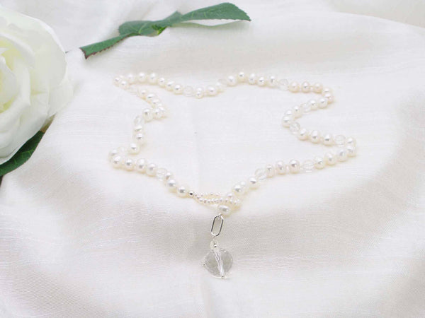 Lariat style single strand of ivory potato pearls sprinkled with micro faceted clear quartz.  Exquisite statement necklace from Jewellery by Linda