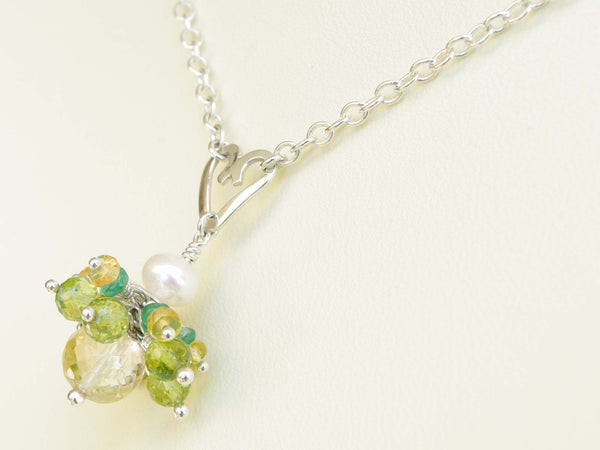 Persephone necklace. Emeralds, yellow sapphires and peridots with a white freshwater cultured pearl and citrine. Suspended from a polished sterling silver handmade heart on a sterling silver chain. Sweet Heart Collection. 46cm chain. 3cm pendant
