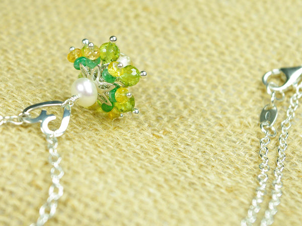 Persephone necklace. Emeralds, yellow sapphires and peridots with a white freshwater cultured pearl and citrine. Suspended from a polished sterling silver handmade heart on a sterling silver chain. Sterling silver necklace. 46cm chain. 3cm pendant