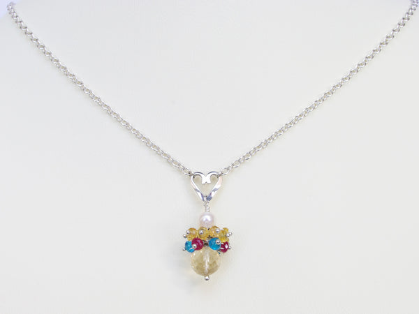 Rebecca necklace. Longido rubies, yellow sapphires and apatites with a white freshwater cultured pearl and citrine. Suspended from a polished sterling silver handmade heart on a sterling silver chain. Sweet Heart Collection. 46cm chain. 3cm pendant