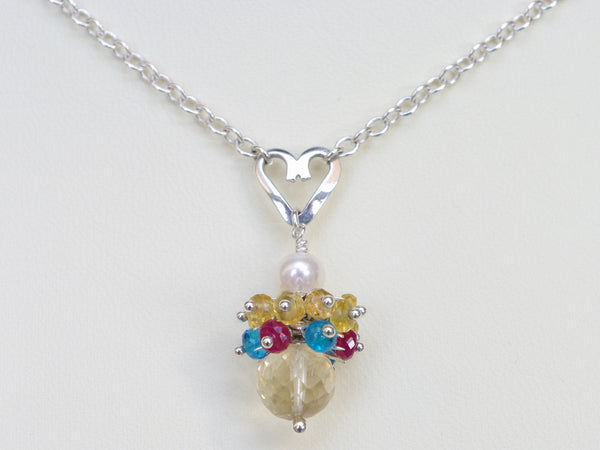 Rebecca necklace. Longido rubies, yellow sapphires and apatites with a white freshwater cultured pearl and citrine. Suspended from a polished sterling silver handmade heart on a sterling silver chain. Sweet Heart Collection. 46cm chain. 3cm pendant