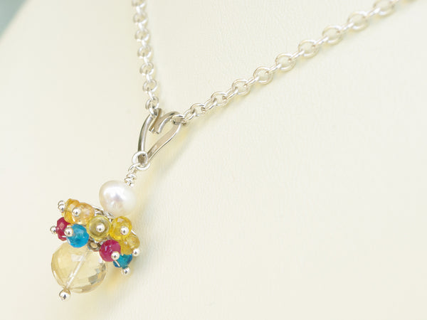 Rebecca necklace. Longido rubies, yellow sapphires and apatites with a white freshwater cultured pearl and citrine. Suspended from a polished sterling silver handmade heart on a sterling silver chain. Sweet Heart Collection. 46cm chain. 3cm pendant