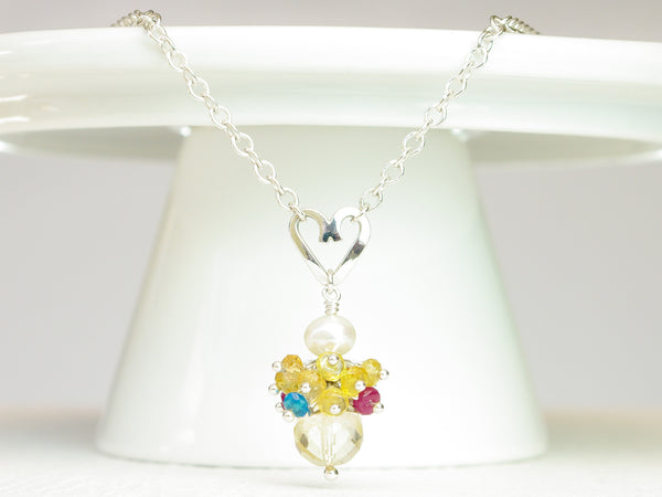 Rebecca necklace. Longido rubies, yellow sapphires and apatites with a white freshwater cultured pearl and citrine. Suspended from a polished sterling silver handmade heart on a sterling silver chain. Sweet Heart Collection. 46cm chain. 3cm pendant