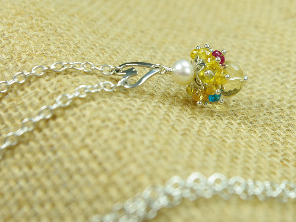 Rebecca necklace. Longido rubies, yellow sapphires and apatites with a white freshwater cultured pearl and citrine. Suspended from a polished sterling silver handmade heart on a sterling silver chain. Sweet Heart Collection. 46cm chain. 3cm pendant