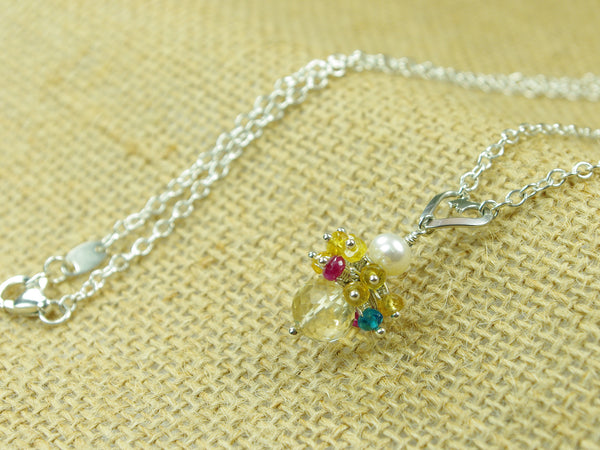 Rebecca necklace. Longido rubies, yellow sapphires and apatites with a white freshwater cultured pearl and citrine. Suspended from a polished sterling silver handmade heart on a sterling silver chain. Sweet Heart Collection. 46cm chain. 3cm pendant