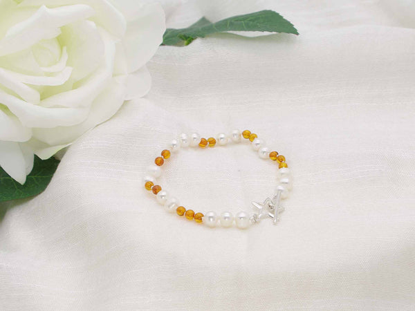 White pearl and cognac amber hand knotted bracelet with sterling silver star toggle clasp from Jewellery by Linda