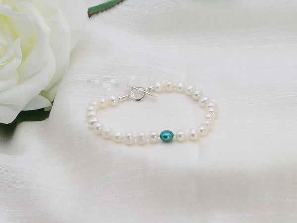 Love Teal white pearl hand knotted bracelet with feature teal pearl and sterling silver heart  and arrow toggle clasp from Jewellery by Linda