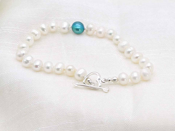 Love Teal white pearl hand knotted bracelet with feature teal pearl and silver heart  and arrow toggle clasp from Jewellery by Linda