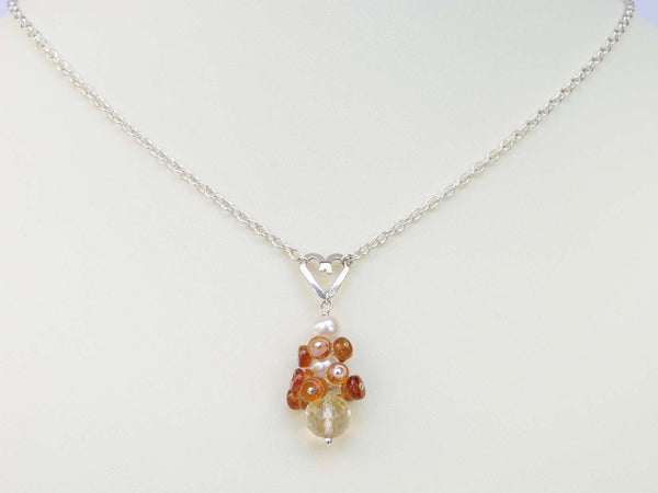 Diana necklace. Jewellery by Linda. Hessonite garnets, with a white freshwater cultured pearl and citrine. Suspended from a polished sterling silver handmade heart on a sterling silver chain. Sweet Heart Collection. 46cm chain. 3.5cm pendant