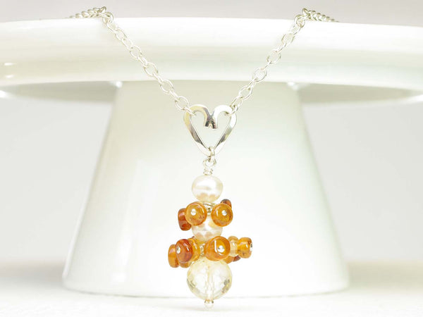 Diana necklace. Hessonite garnets, with a white freshwater cultured pearl and citrine. Suspended from a polished sterling silver handmade heart on a sterling silver chain. Sweet Heart Collection from Jewellery by Linda. 46cm chain. 3.5cm pendant