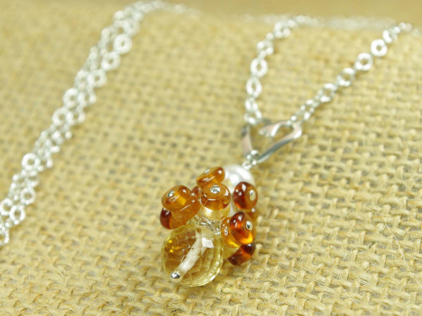Diana necklace. Hessonite garnets, with a white freshwater cultured pearl and citrine. Suspended from a polished sterling silver handmade heart on a sterling silver chain. Sweet Heart Collection. 46cm chain.  Jewellery by Linda