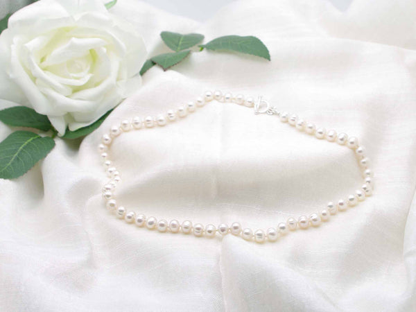 Regal white cultured pearl knotted necklace with crown toggle clasp from Jewellery by Linda