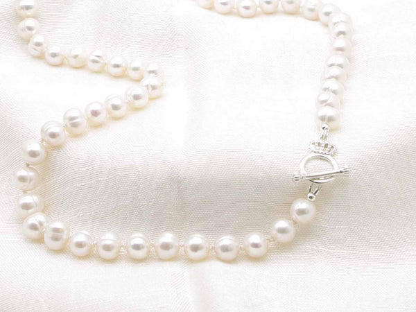 Classic single strand of white cultured hand knotted pearls necklace with sterling silver crown toggle clasp from Jewellery by Linda