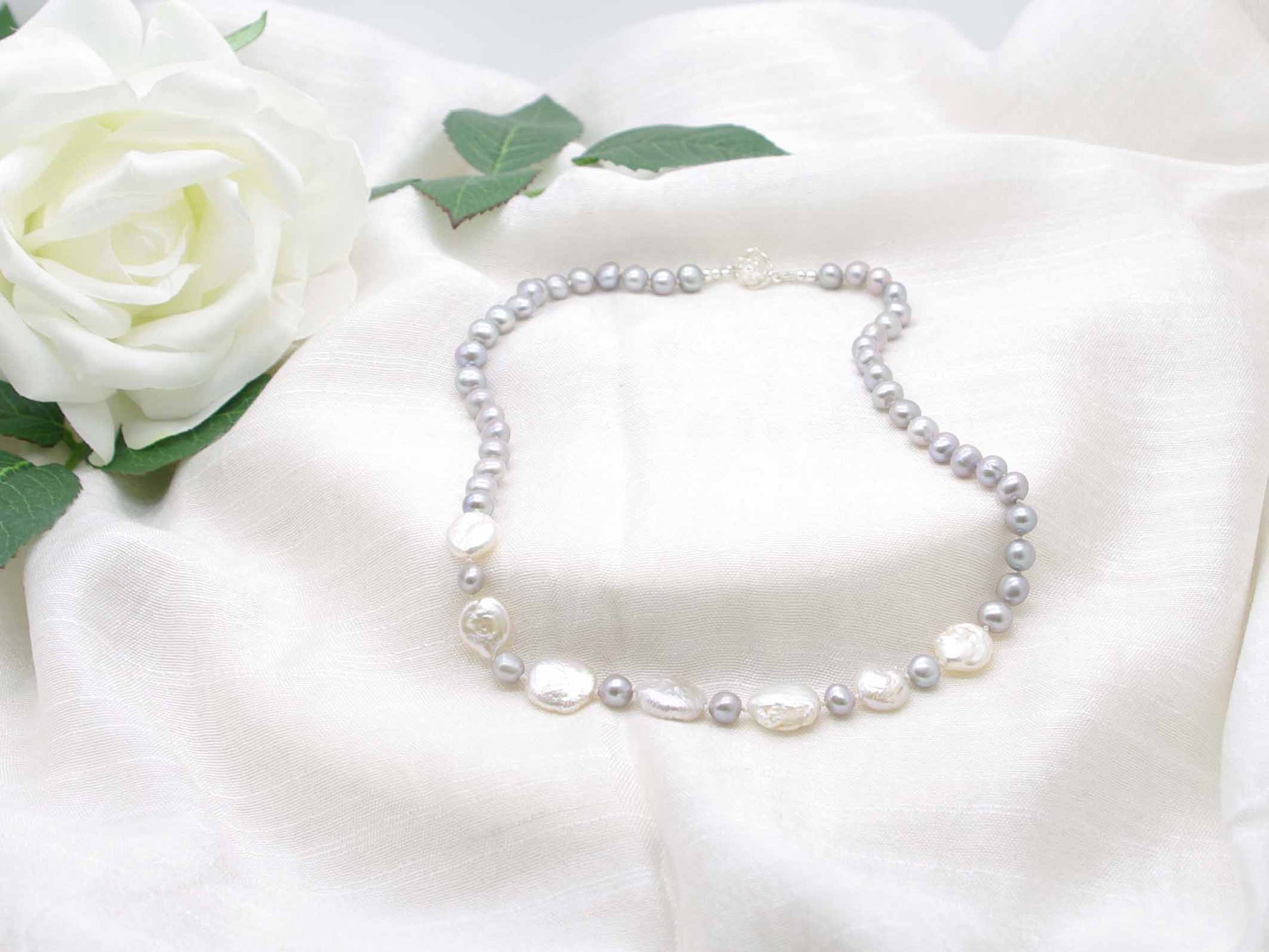 Distinctive hand knotted silver grey pearl necklace with striking iridescent silver coin pearls from Jewellery by Linda 