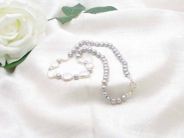 Distinctive hand knotted silver grey pearl necklace with striking iridescent silver coin pearls from Jewellery by Linda. Contemporary relaxed elegance.