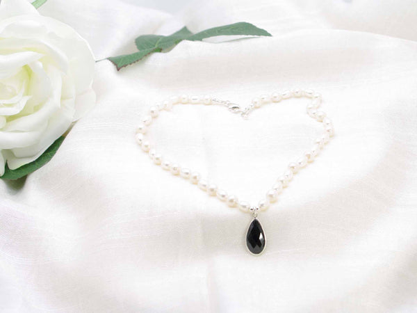 Vintage inspired hand knotted ivory culture pearl necklace with striking feature black spinel faceted drop.  Elegant monochrome sophistication.