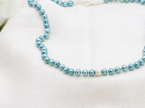 Sophisticated single strand of teal hand knotted pearls featuring a stardust sterling silver sphere from Jewellery by Linda