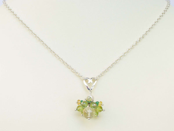 Persephone necklace. Emeralds, yellow sapphires and peridots with a white freshwater cultured pearl and citrine. Suspended from a polished sterling silver handmade heart on a sterling silver chain. Sweet Heart Collection. 46cm chain. 3cm pendant