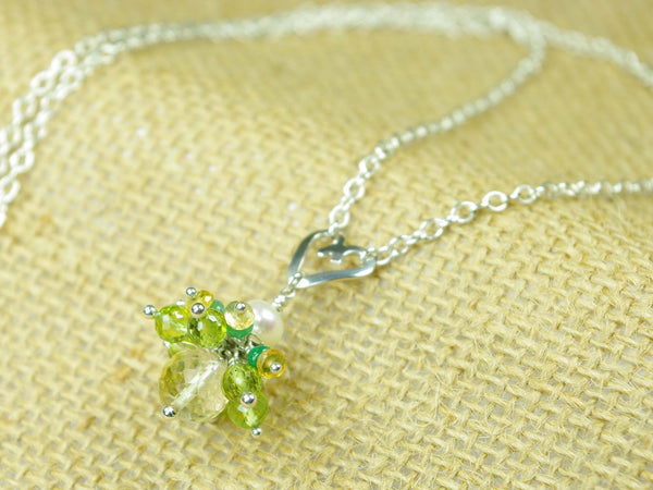Persephone necklace. Emeralds, yellow sapphires and peridots with a white freshwater cultured pearl and citrine. Suspended from a polished sterling silver handmade heart on a sterling silver chain. One of a kind. 46cm chain. 3cm pendant