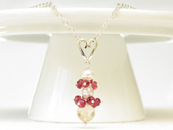 Roslyn necklace. Red spinel with a white freshwater cultured pearl and citrine. Suspended from a polished sterling silver handmade heart on a sterling silver chain. Sweet Heart Collection. 46cm chain. 3.5cm pendant